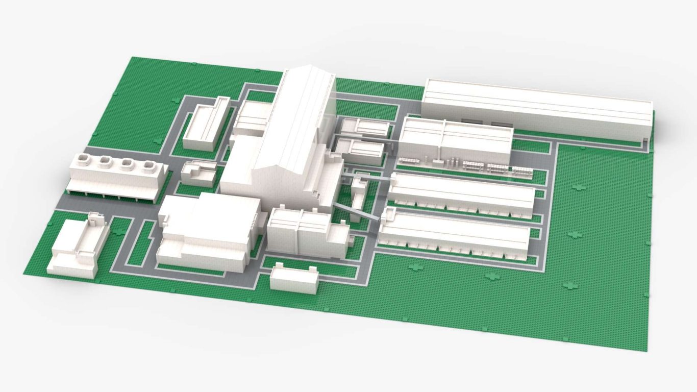Maqueta Fusion for Energy realizada con piezas lego Maqueta de un complejo industrial con edificios en disposición ordenada sobre una base verde.